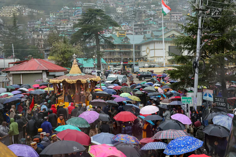 People participate in a religious procession in Kullu amid rain. (Photo: PTI)